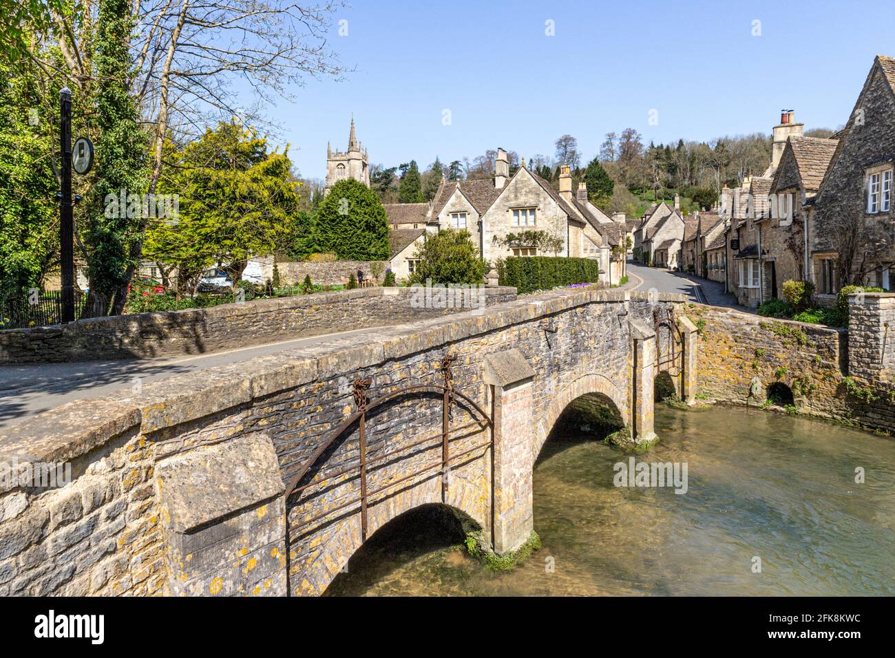 The bridge over the By Brook in the Cotswold village of Castle Combe, Wiltshire UK Stock Photo