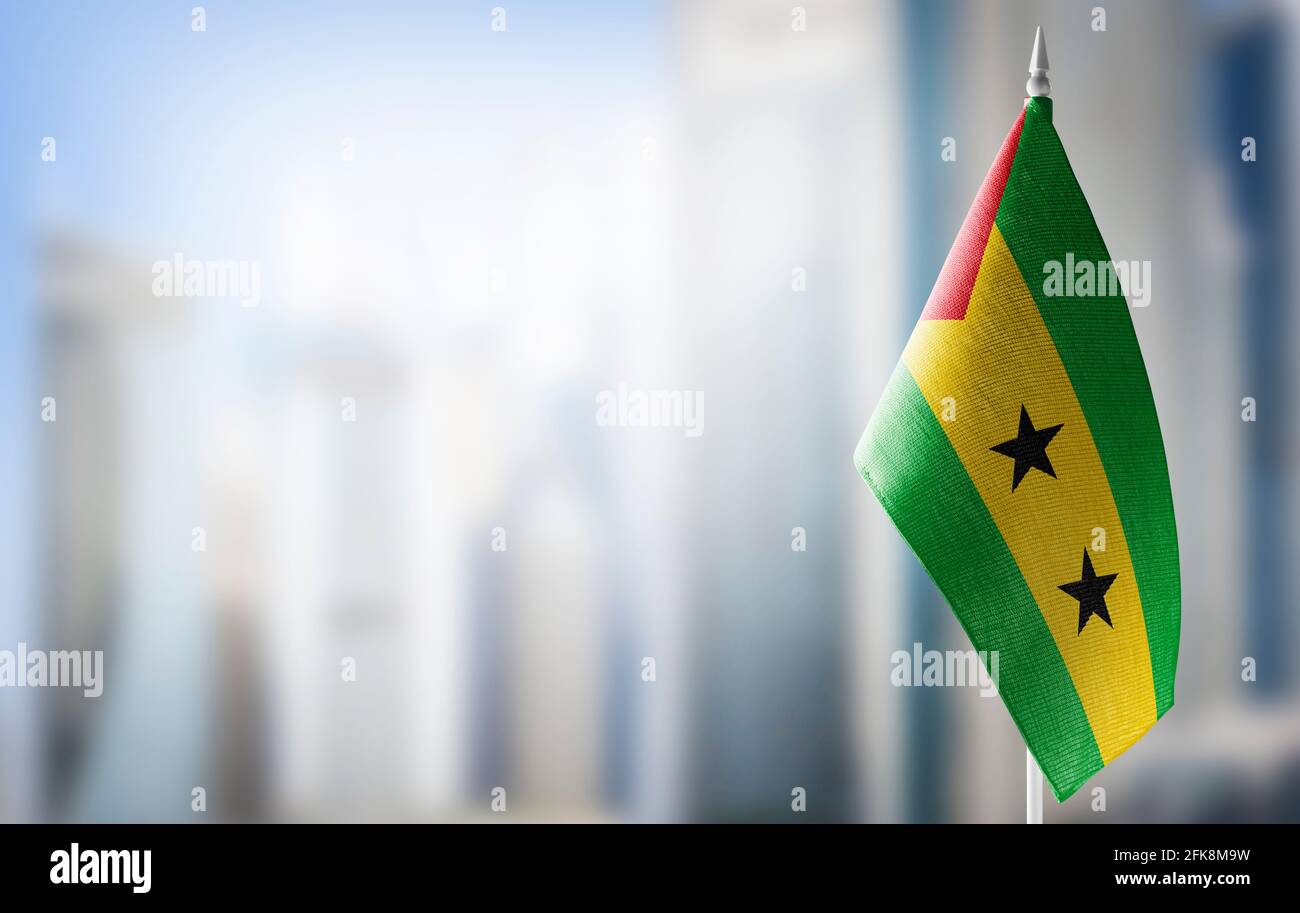 A small flag of Sao Tome and Principe on the background of a blurred background Stock Photo