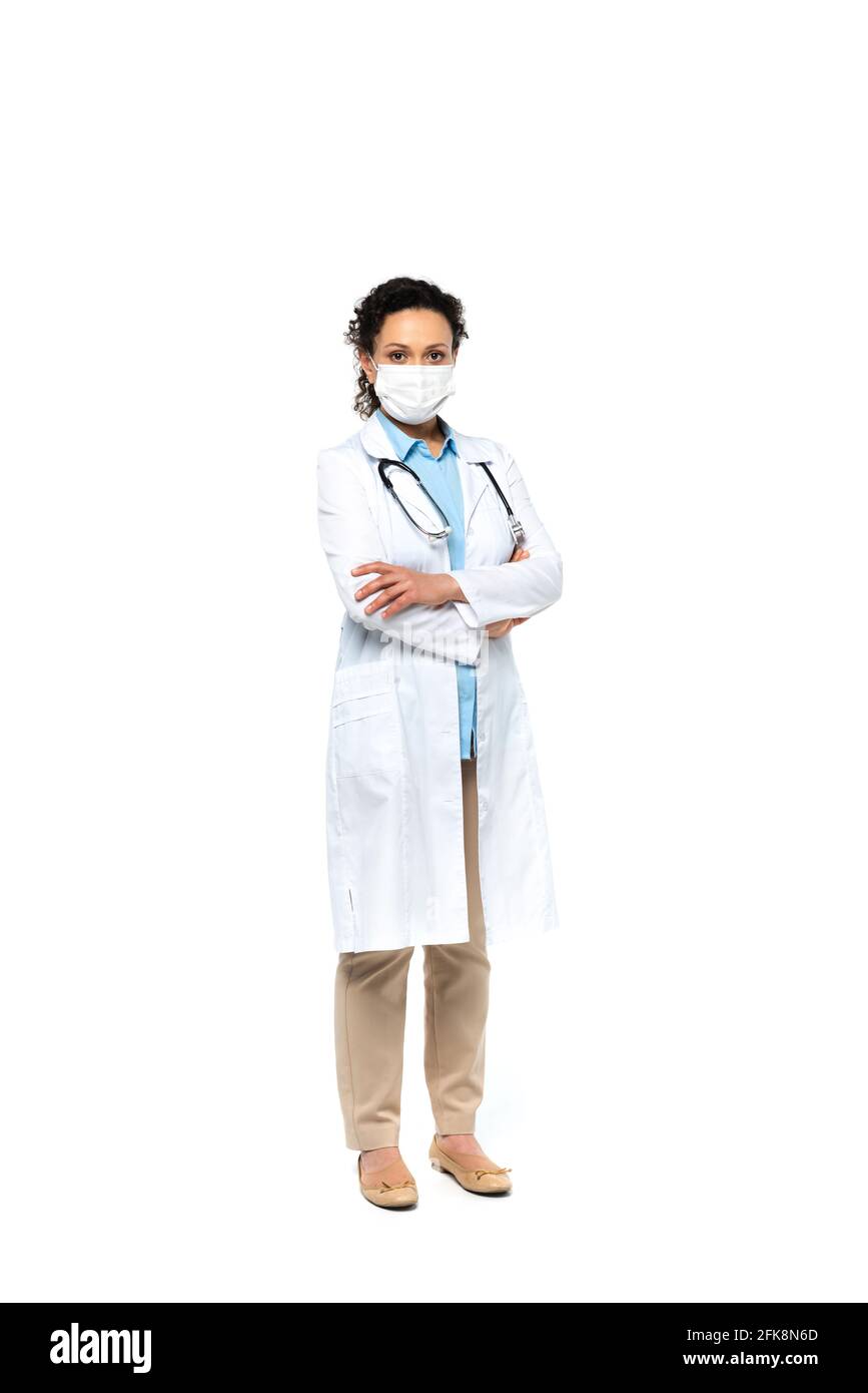 African american doctor in medical mask standing with crossed arms on ...