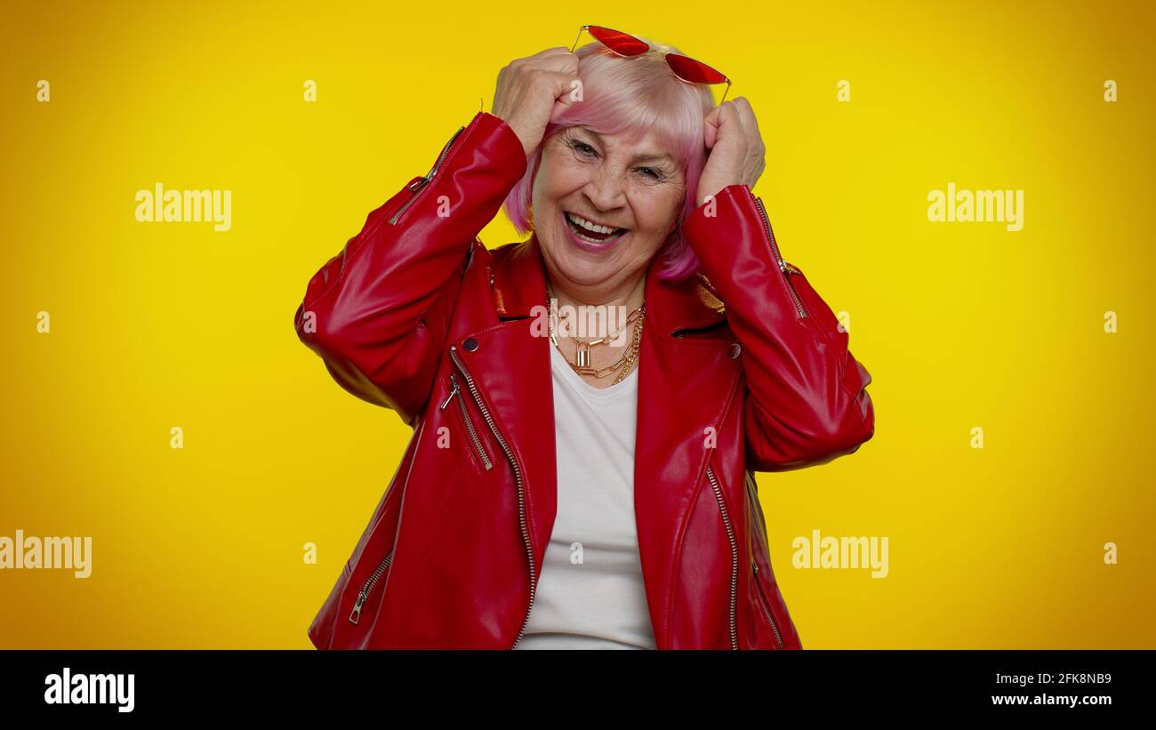Happy joyful senior old granny woman laughing out loud after hearing ridiculous anecdote, funny joke Stock Photo