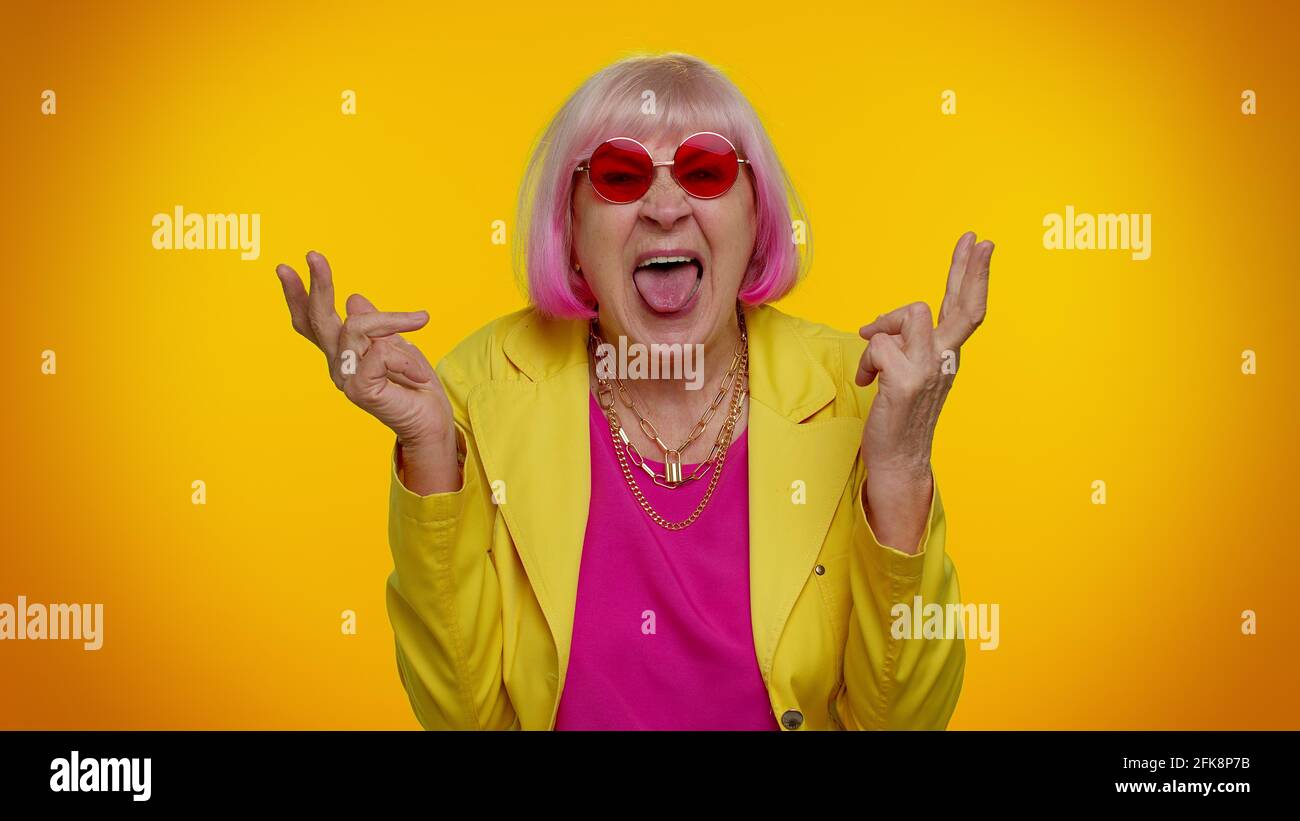 Senior old grandma woman making playful silly face expressions, grimacing,  fooling, showing tongue Stock Photo - Alamy