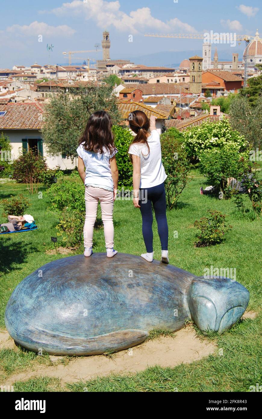 Florence, Italy Little girls above the cat statue by Jean Michel Folon at the rose garden. Stock Photo
