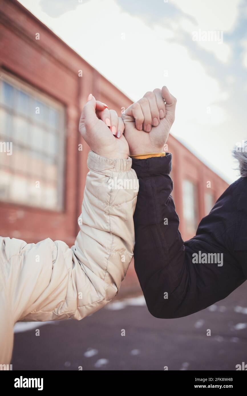 Elbow bump. New novel greeting to avoid the spread of coronavirus. Couple friends meet in street and instead of greeting with a hug or handshake Stock Photo