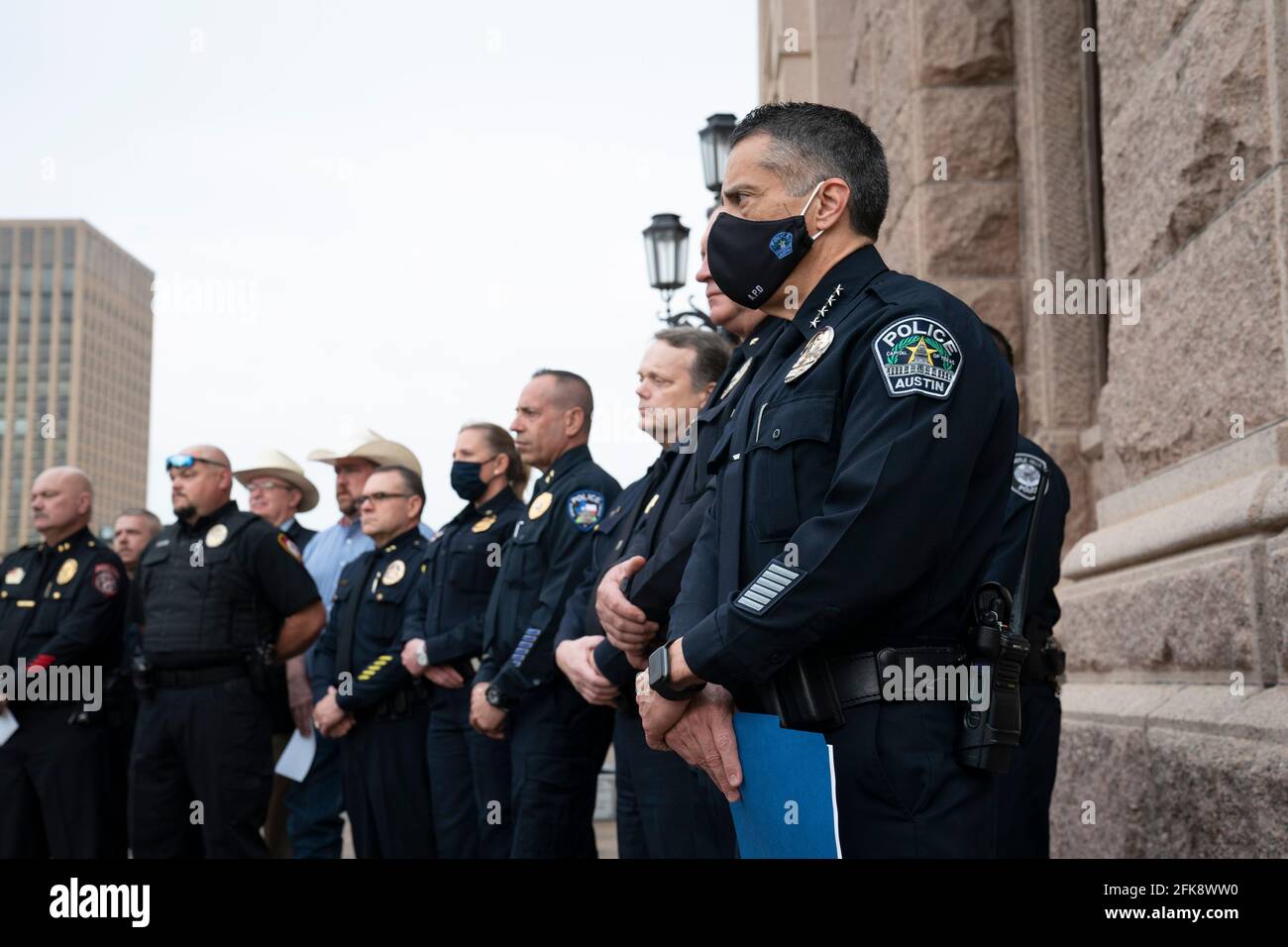 Austin, TX USA May 29, 2021: Texas police chiefs and commanders, including Joseph Chacon of Austin, far right, stand on the south steps of the Texas Capitol opposing bills in the Senate that would allow anyone over 21 to publicly carry a handgun with no licensing or training requirement. Police leaders argue it will make their jobs harder as gun crimes are spiking statewide. Credit: Bob Daemmrich/Alamy Live News Stock Photo