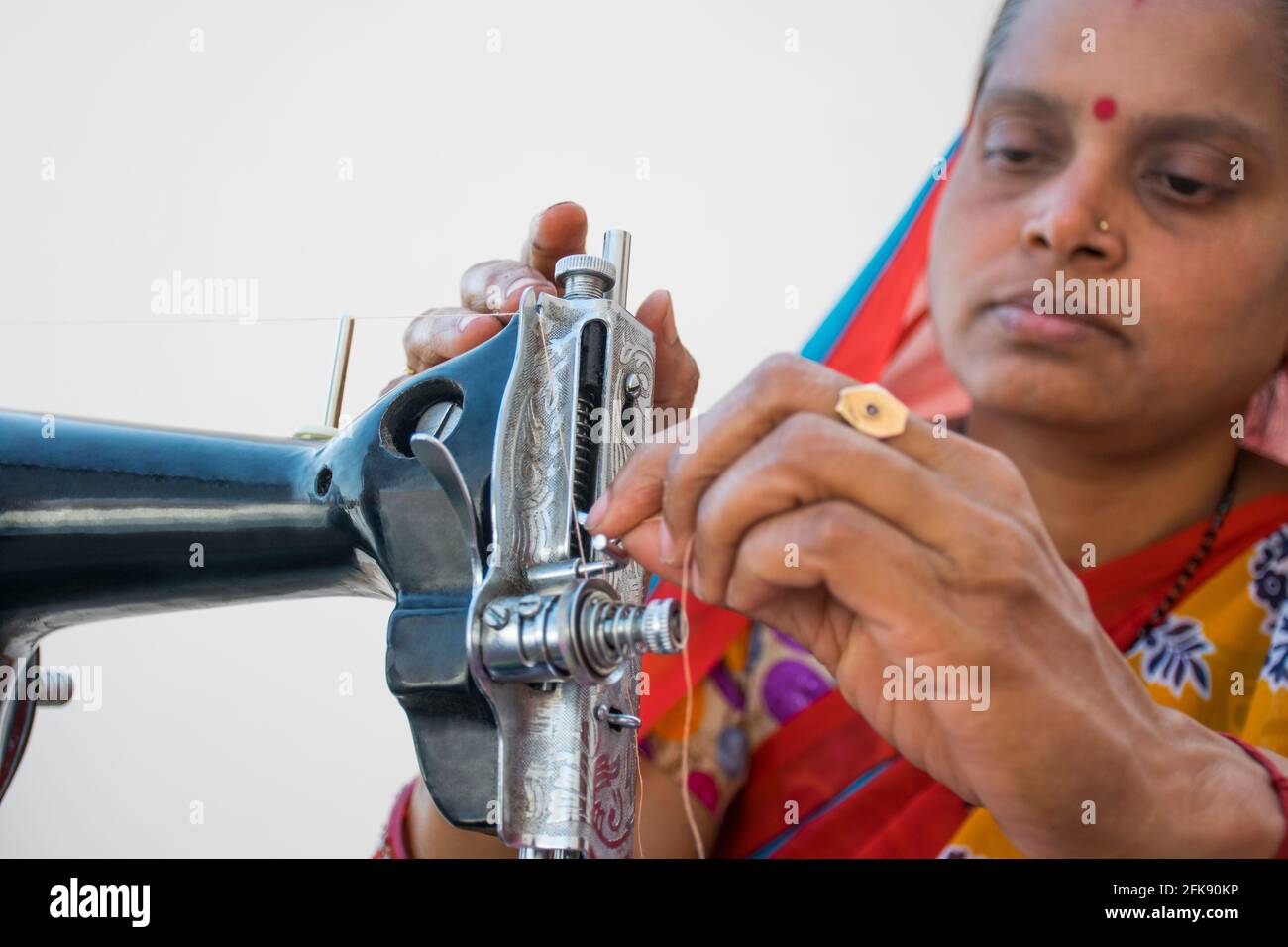 CLOSE-UP RURAL WOMAN using sewing machine Stock Photo