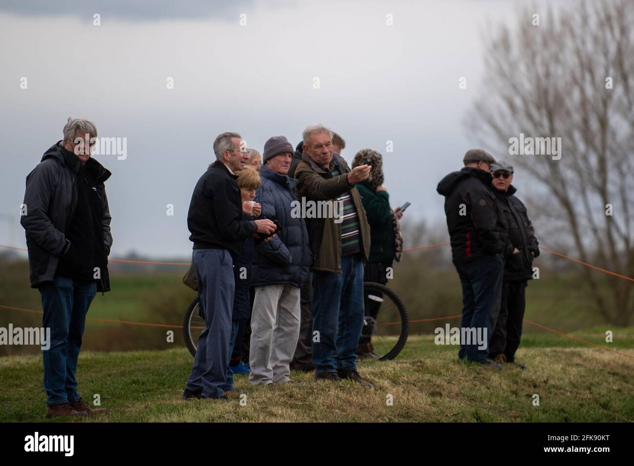 People look on as a 26-foot-long Buffalo tank is extracted from the earth in Crowland, Lincolnshire, where it has been buried for 74 years since it was brought into the village to help during heavy floods in March 1947. Sixteen of the amphibious Buffalo tanks were used to help seal the breach when a combination of heavy snow, high tides, rain and wind caused the River Welland to break its banks. Picture date: Thursday April 29, 2021. Stock Photo