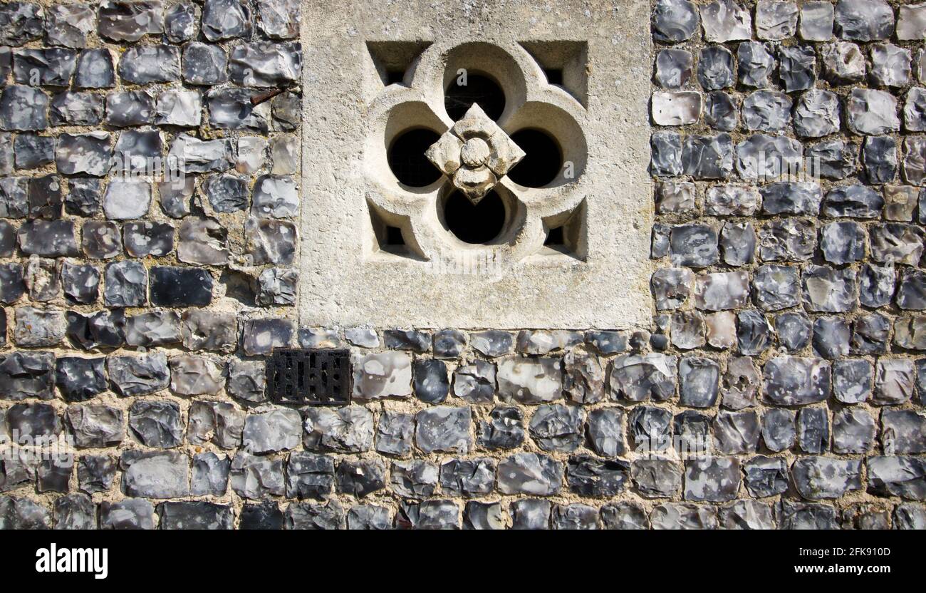 English grey flint wall with embedded cement decorative architectural feature Stock Photo