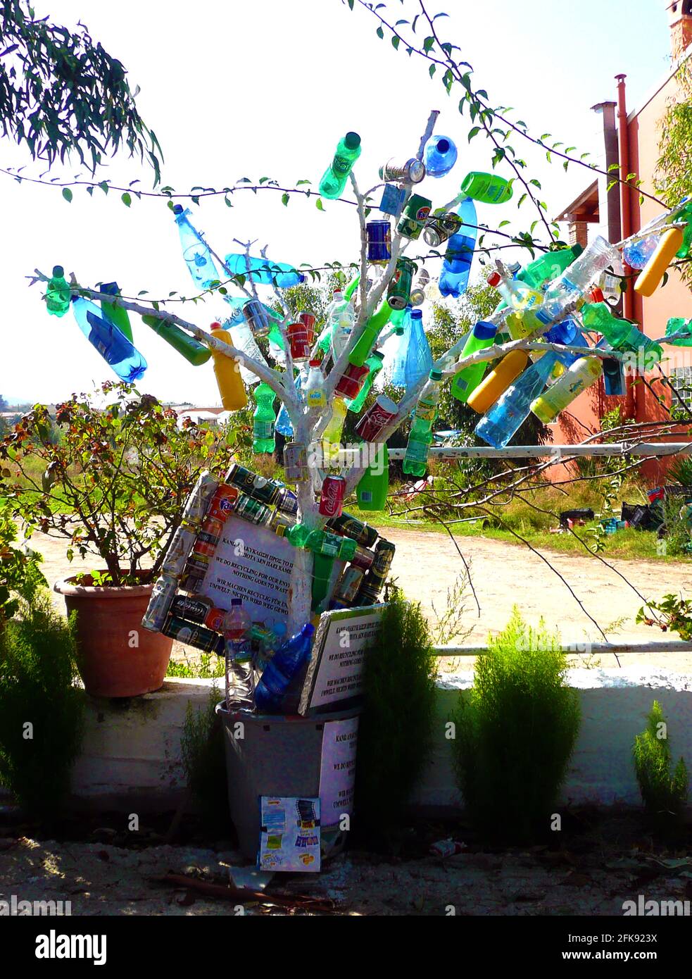 'GREEN' CORFU 2012 - Recycled  plastic bottles , drink cans etc forming a tree, Because it's an island, Corfu is responsible for processing its own waste, and citizens have come up with a number of  their own schemes to make use of waste items ranging from paper, glass, plastic, tins and packaging materials to household appliances, batteries, iron, aluminium and even motor cars. Stock Photo