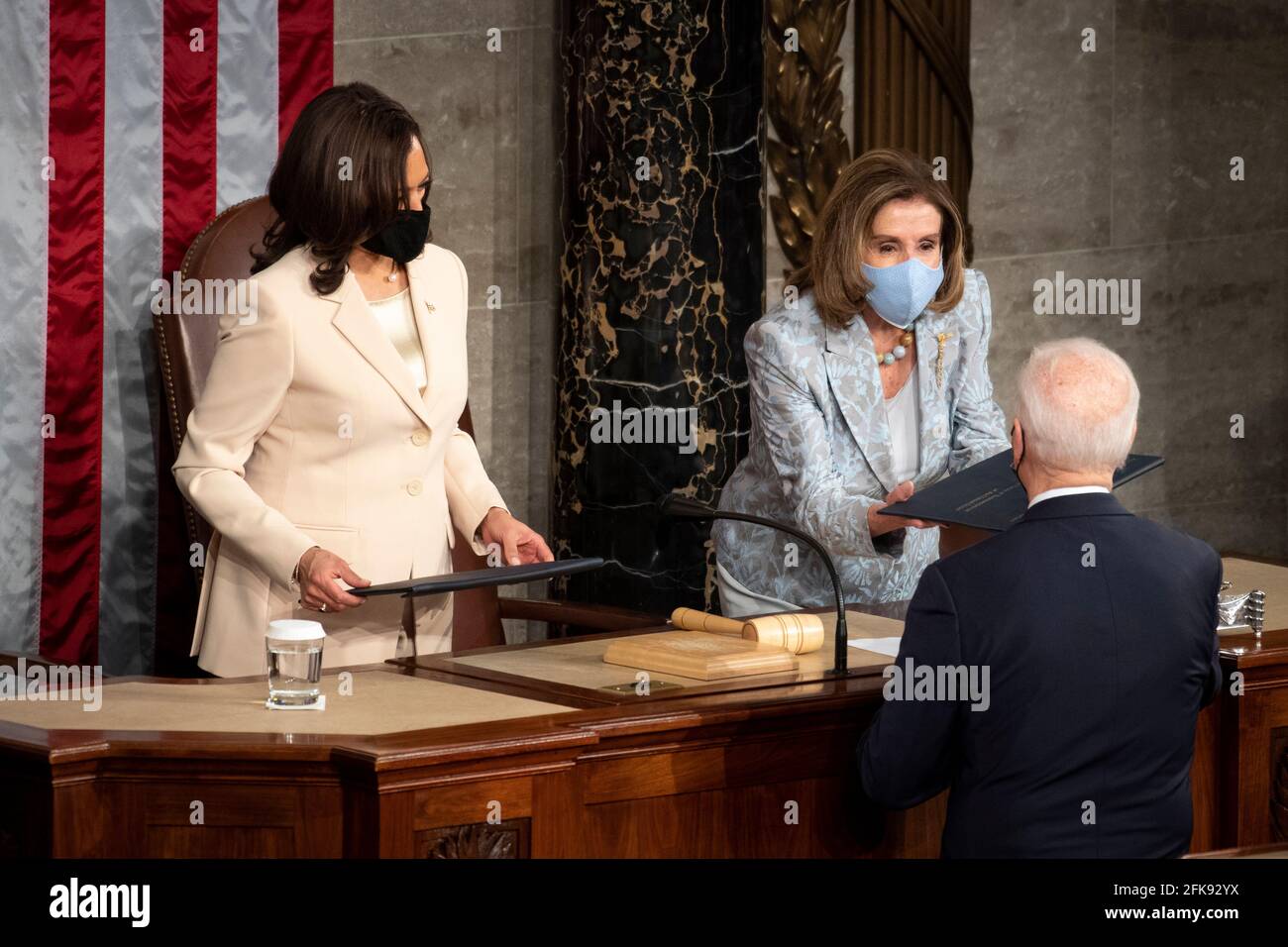 Washington, USA. 28th Apr, 2021. UNITED STATES - April 28: President Joe Biden hands a copy of his speech to Speaker of the House Nancy Pelosi, D-Calif., after delivering his address to the joint session of Congress in the U.S. Capitol in Washington on Wednesday, April 28, 2021. (Photo by Caroline Brehman/Pool/Sipa USA) Credit: Sipa USA/Alamy Live News Stock Photo