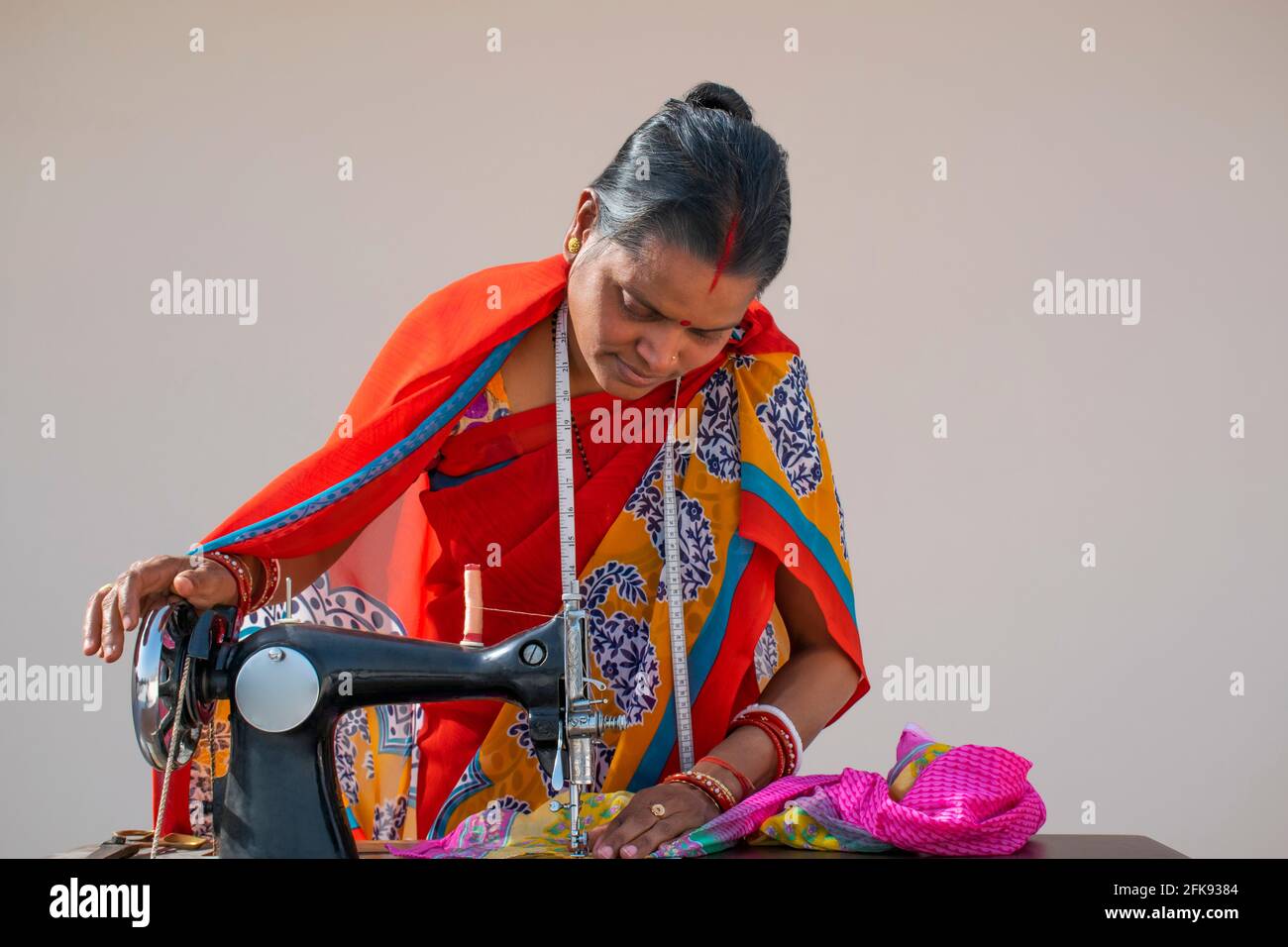 Indian woman stitching cloths by machine in rural India Stock Photo Alamy