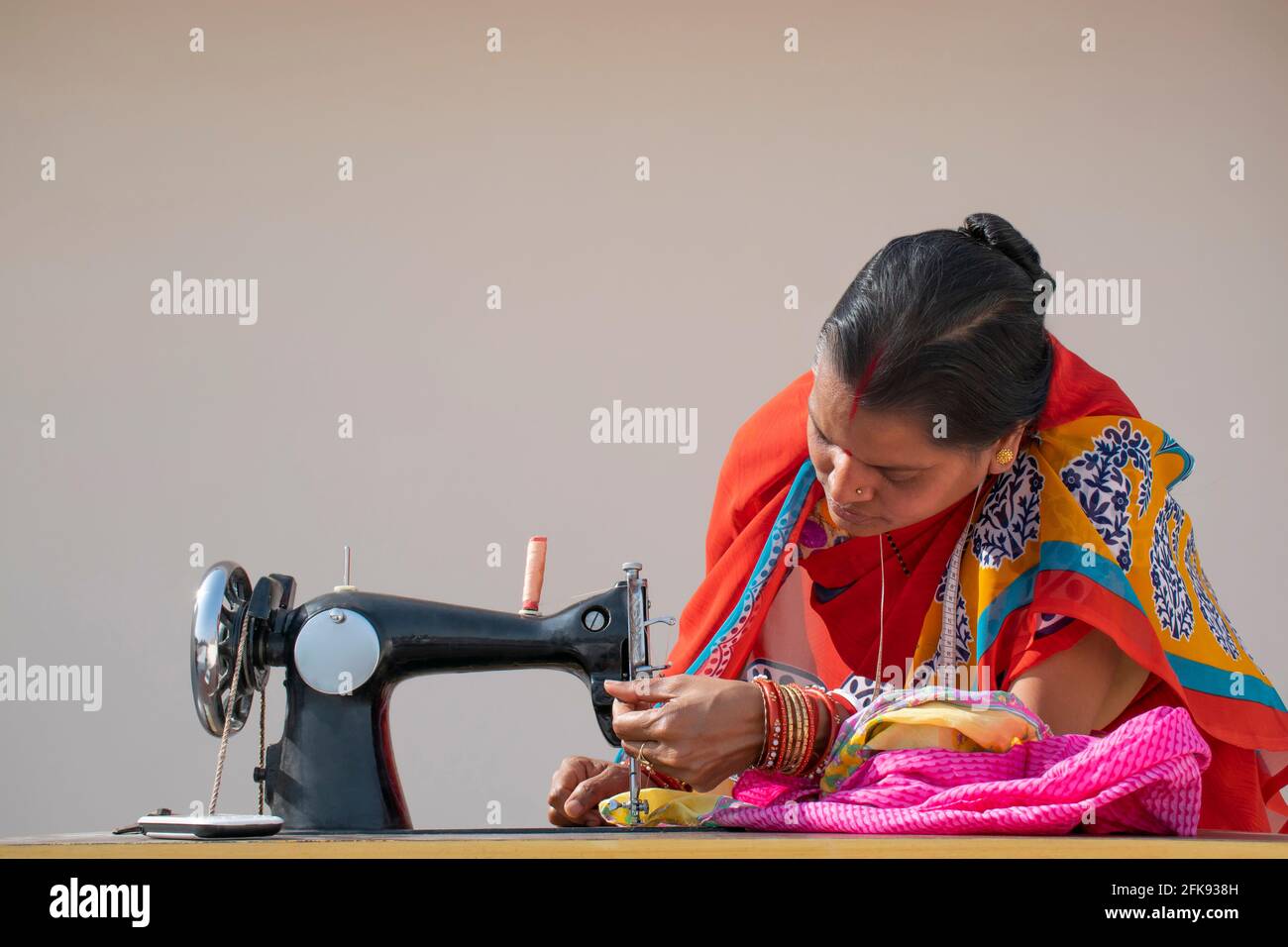Indian woman stitching cloths by machine in rural India Stock Photo Alamy