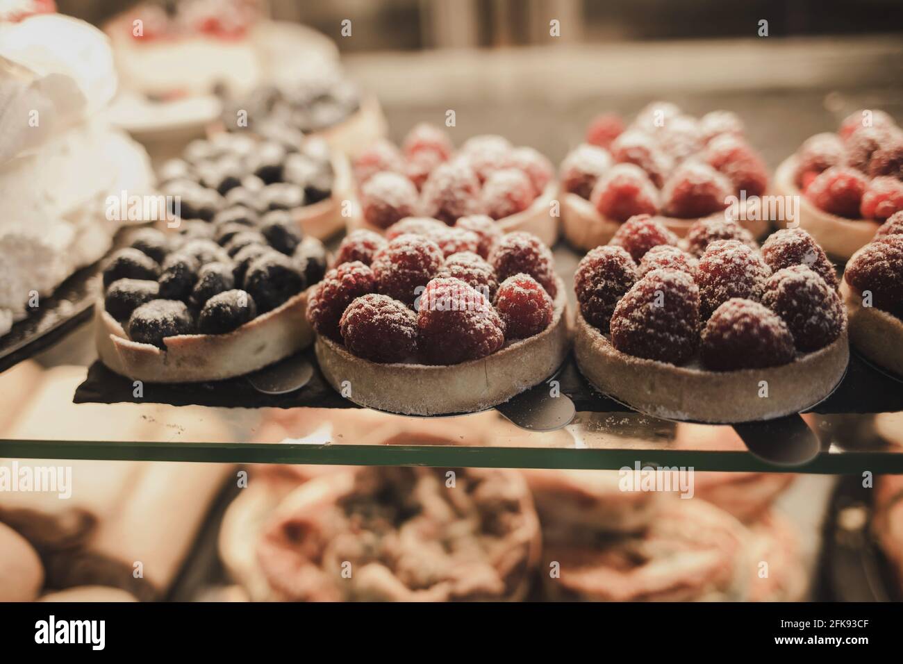 delicious cakes with raspberries and on the shelf in the bakery Stock