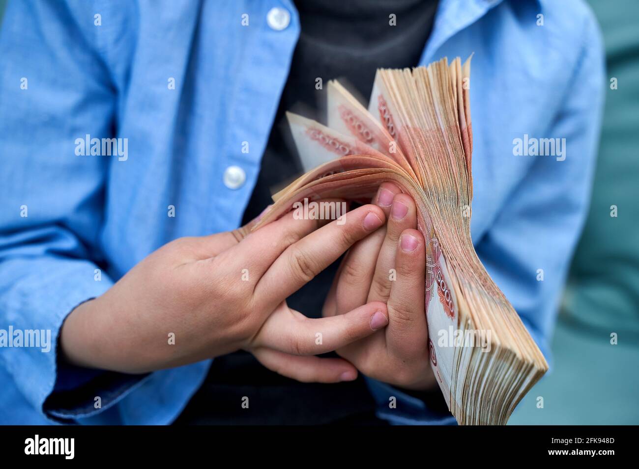 hands close-up consider a large currency of Russian rubles Stock Photo