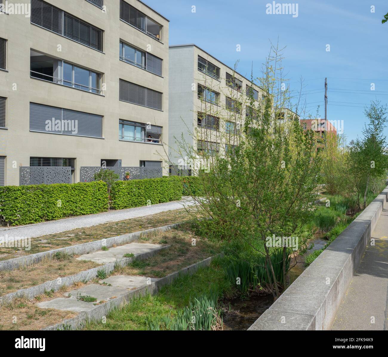 Zurich, Switzerland - April 19th 2020: A small stream being restored in the course of a housing project Stock Photo