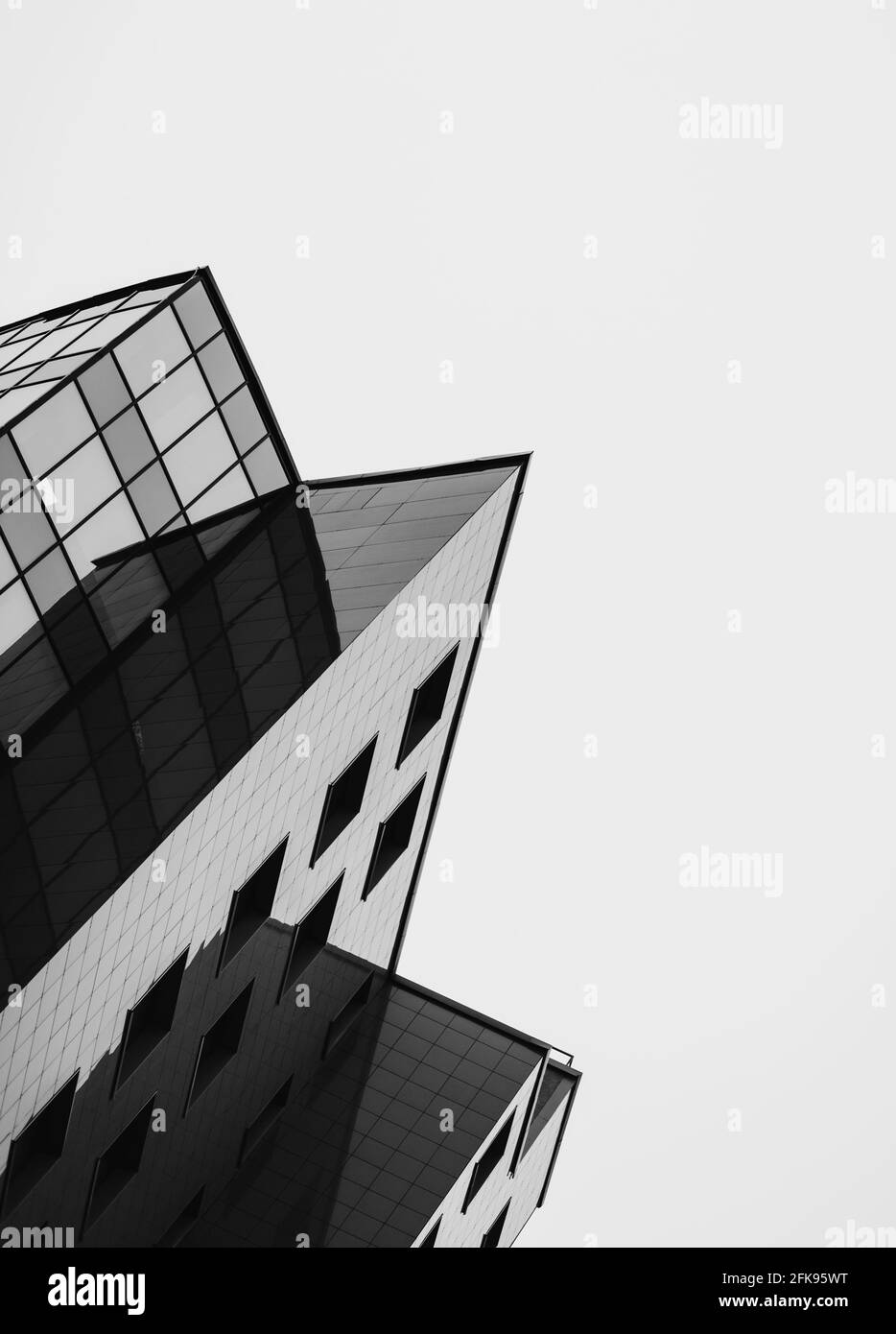 Urban geometry with sharp corner. Modern architecture, glass and steel. Stock Photo