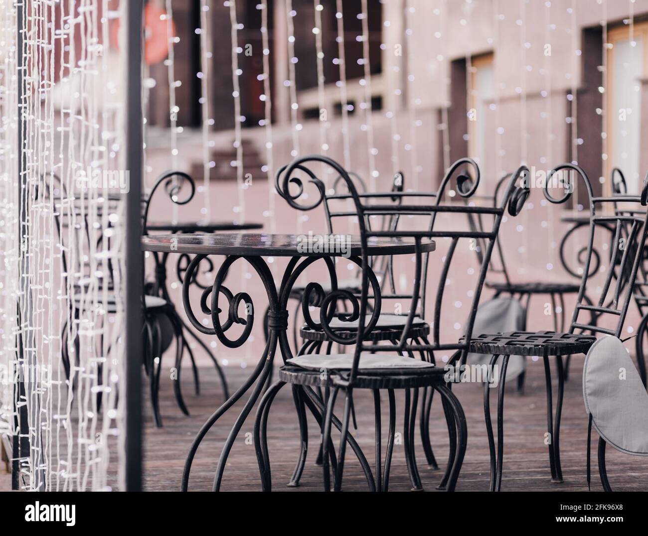 street cafe with vintage wrought iron chairs Stock Photo Alamy