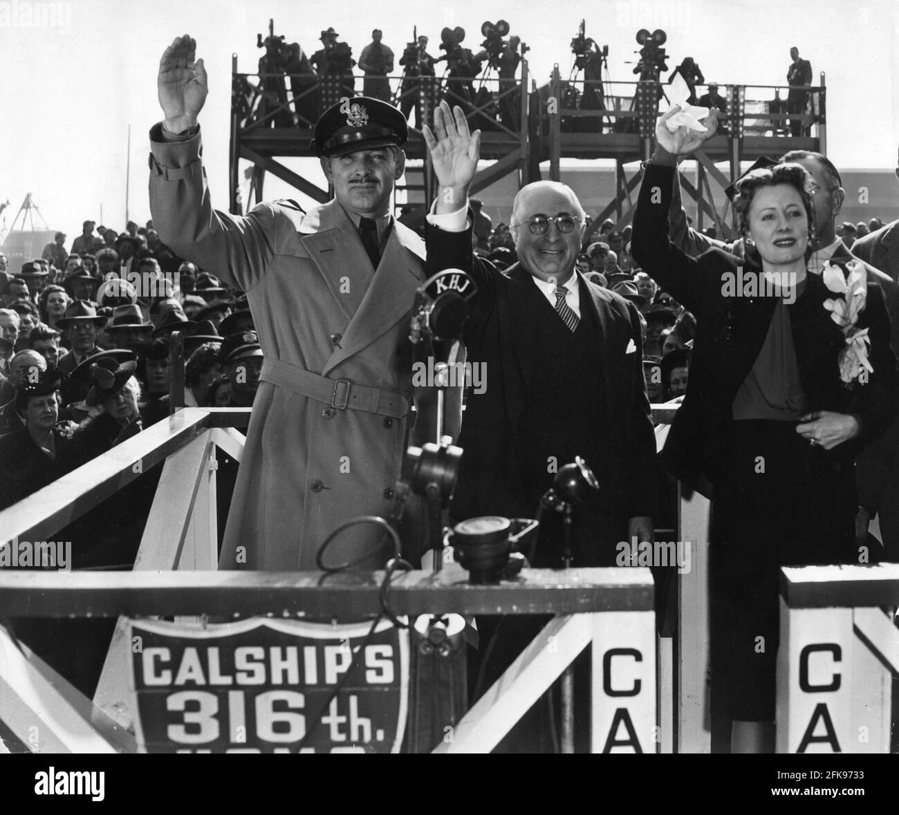 Captain CLARK GABLE of the U.S. Army Air Forces LOUIS B. MAYER and IRENE DUNNE wave to the departing ship at the christening ceremony for the Liberty Ship U.S.S. CAROLE LOMBARD on Saturday January 15th 1944 at the Terminal Island Docks between the Port of Los Angeles and Port of Long Beach, California Stock Photo