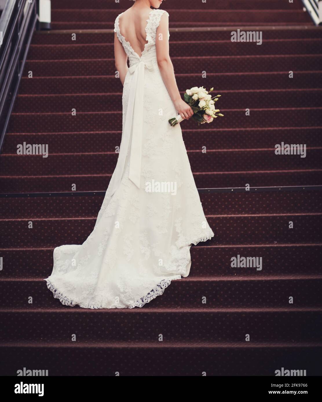 beautiful bride with a bouquet of flowers standing on the steps Stock ...