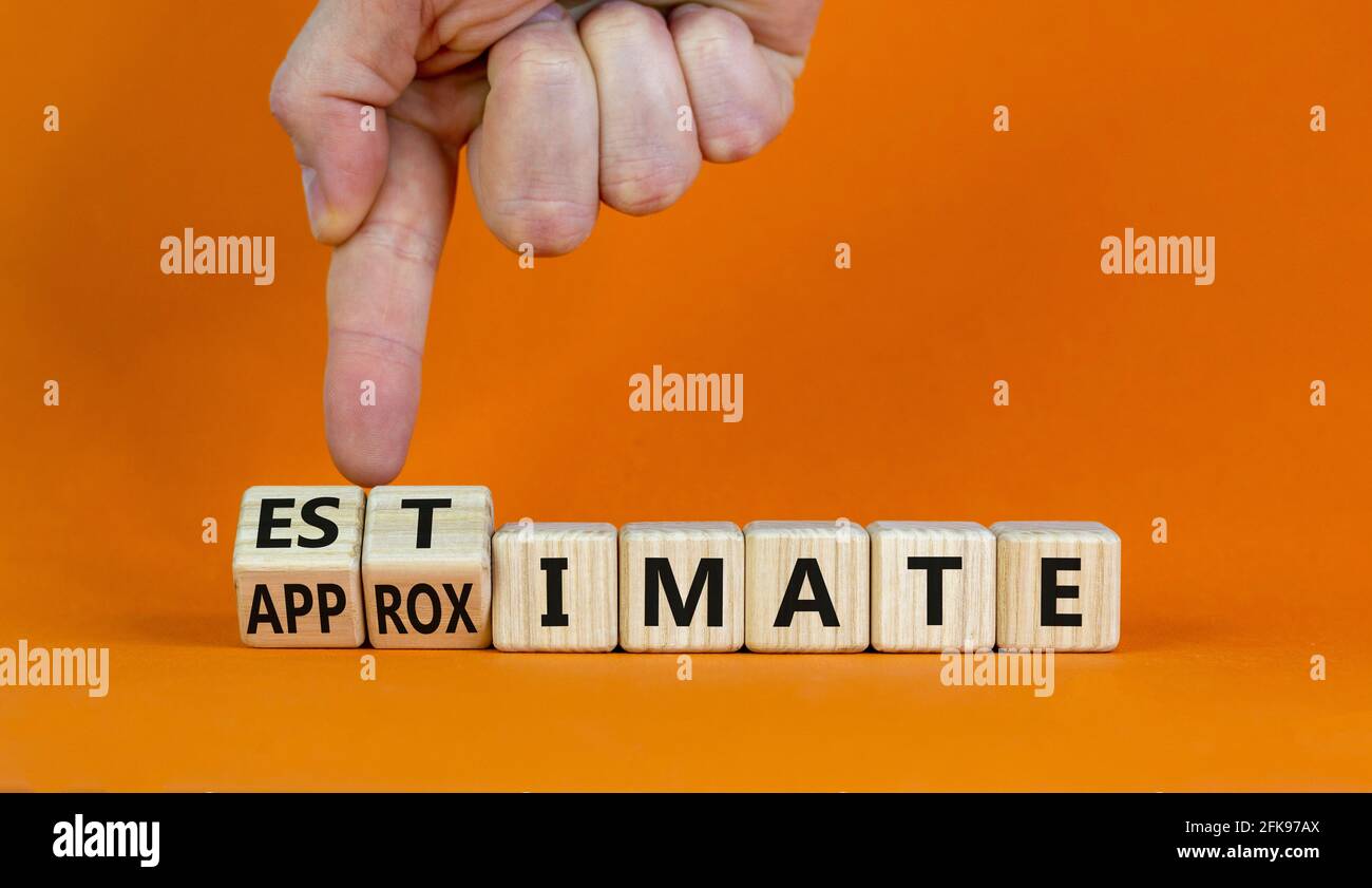 Estimate or approximate symbol. Businessman turns wooden cubes and changes the word 'approximate' to 'estimate'. Beautiful orange background, copy spa Stock Photo