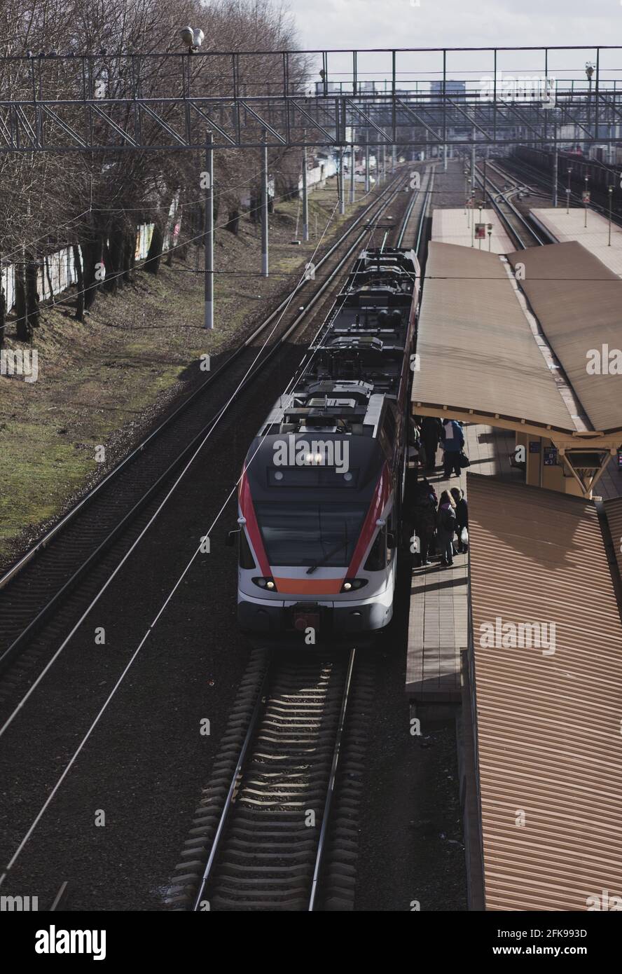 Enter Train passengers at the railway station enter in modern train Stock Photo - Alamy