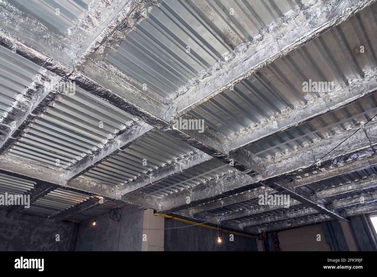 Foil insulation. Insulation of the steel frame of the building with ...