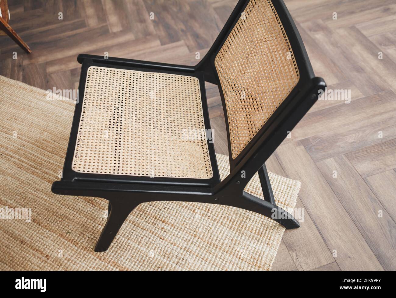 classic wicker chair on the carpet in a stylish interior Stock Photo