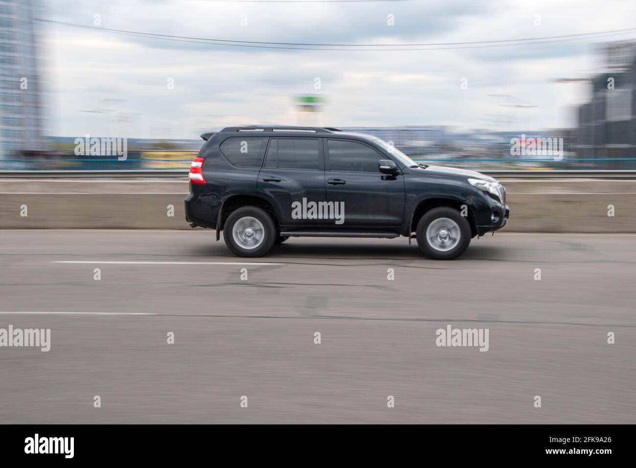 Ukraine, Kyiv - 20 April 2021: Black Toyota Land Cruiser Prado car moving on the street. Editorial Stock Photo