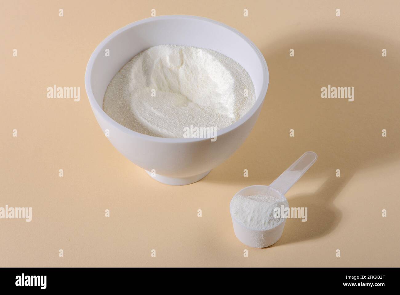 Collagen powder on beige background. Natural beauty and health supplement for skin and bones. Close up. Stock Photo