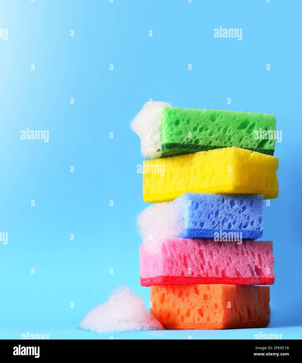sponges cleaning kit isolated on blue background and foam Stock Photo