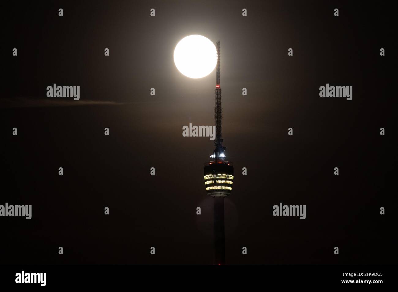 super full moon behind the Stuttgart TV Tower - the antenna is touching the  moon Stock Photo - Alamy