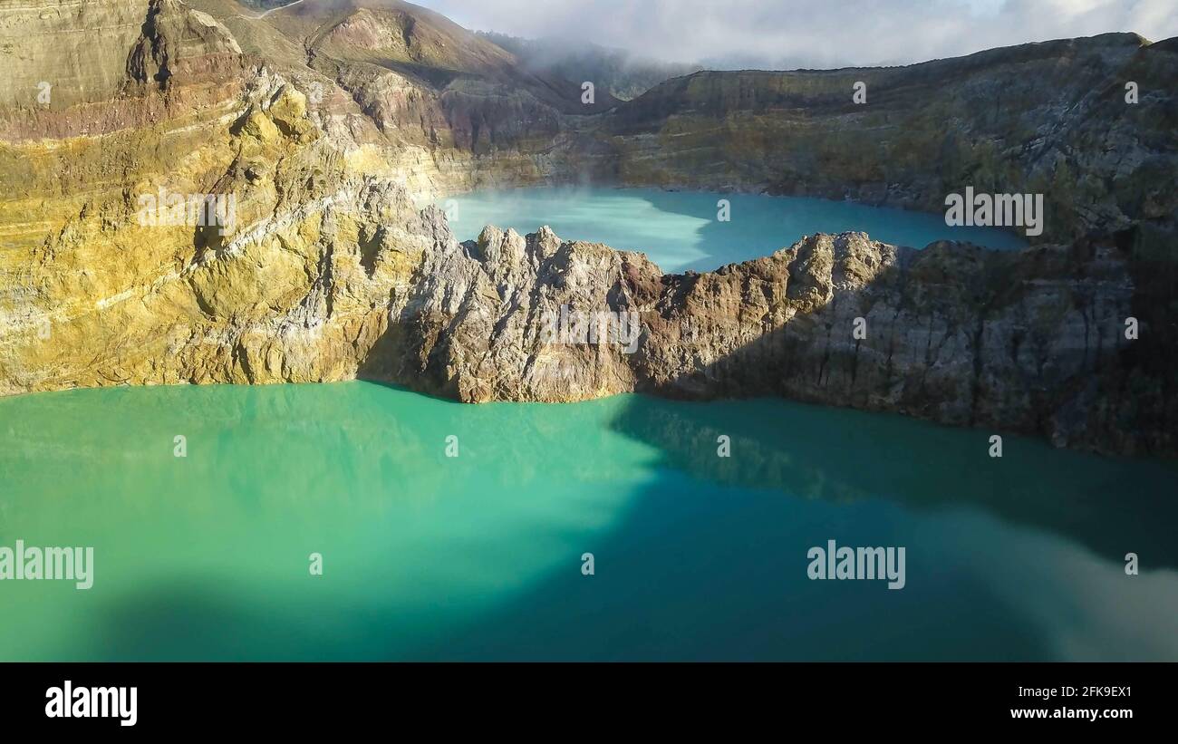 View of the crater wall above the turquoise lake Kootainuamuri. Kelimutu - Turquoise colored volcanic lake Stock Photo