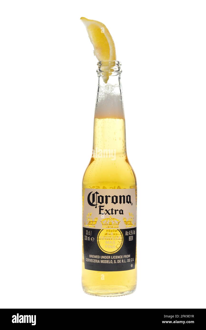 London, United Kingdom - March 26, 2021: Cold Bottle of Corona Extra Beer with a slice of lemon.  Corona Extra is an Imported Beer from Mexico Stock Photo