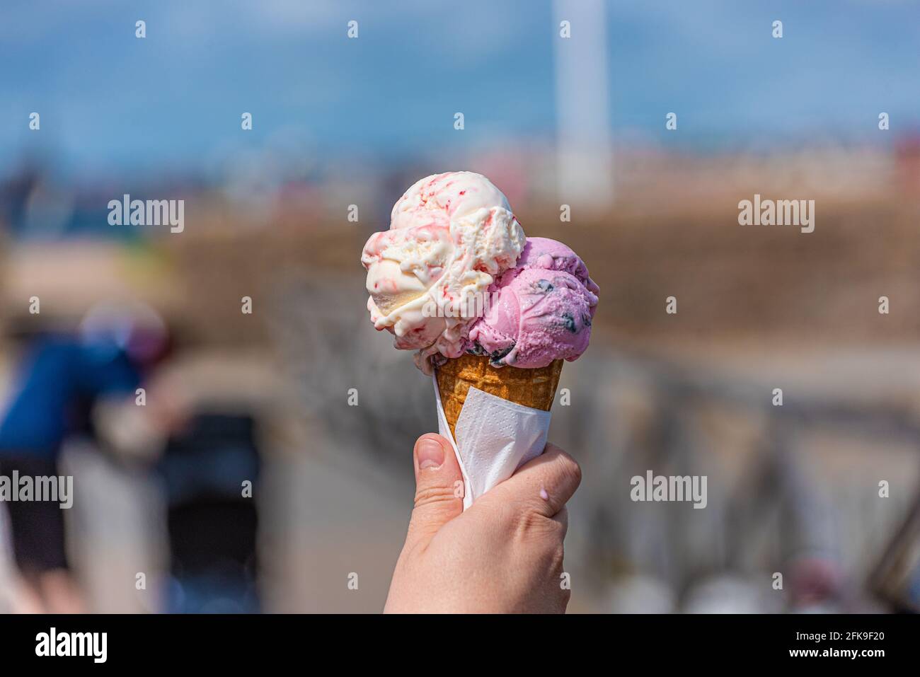 Pink and white ice cream in a cone melting in the sun Stock Photo Alamy