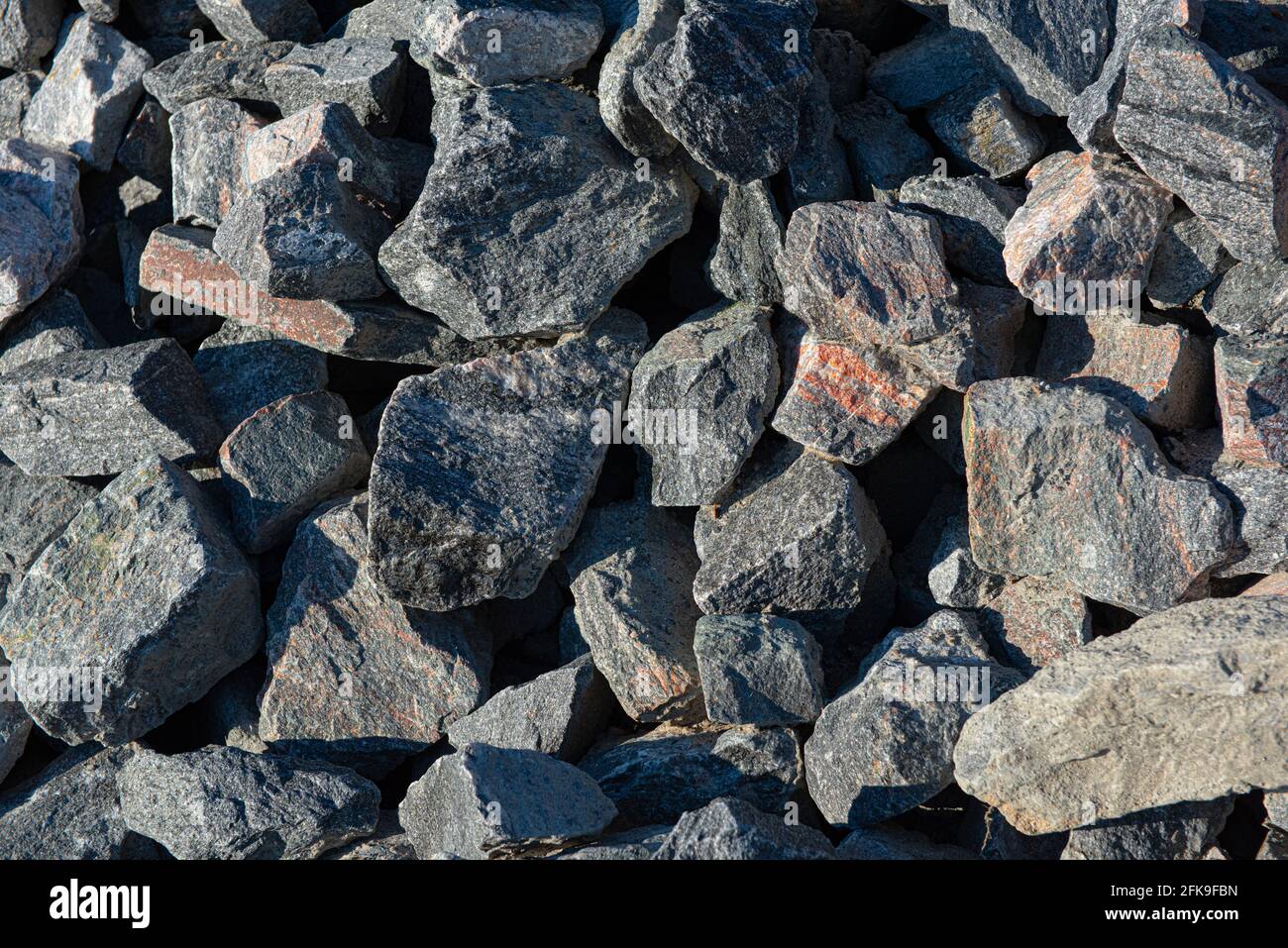 A pile of grey and some pink rocks Stock Photo - Alamy