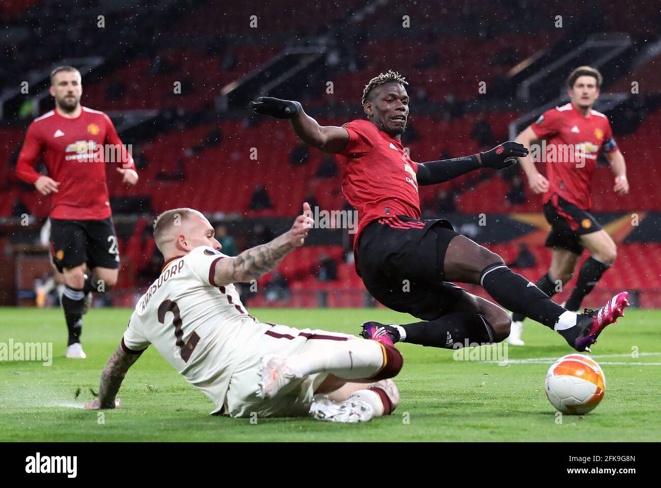 Roma's Rick Karsdorp challenges Manchester United's Paul Pogba during the UEFA Europa League Semi Final First Leg match at Old Trafford, Manchester. Picture date: Thursday April 29, 2021. Stock Photo