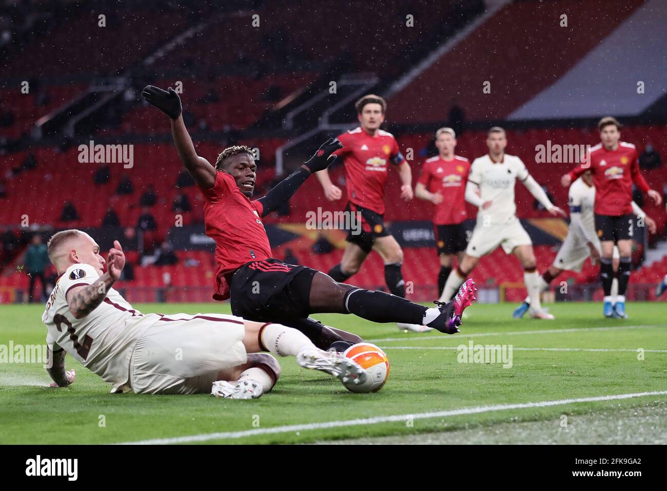 Roma's Rick Karsdorp challenges Manchester United's Paul Pogba during the UEFA Europa League Semi Final First Leg match at Old Trafford, Manchester. Picture date: Thursday April 29, 2021. Stock Photo