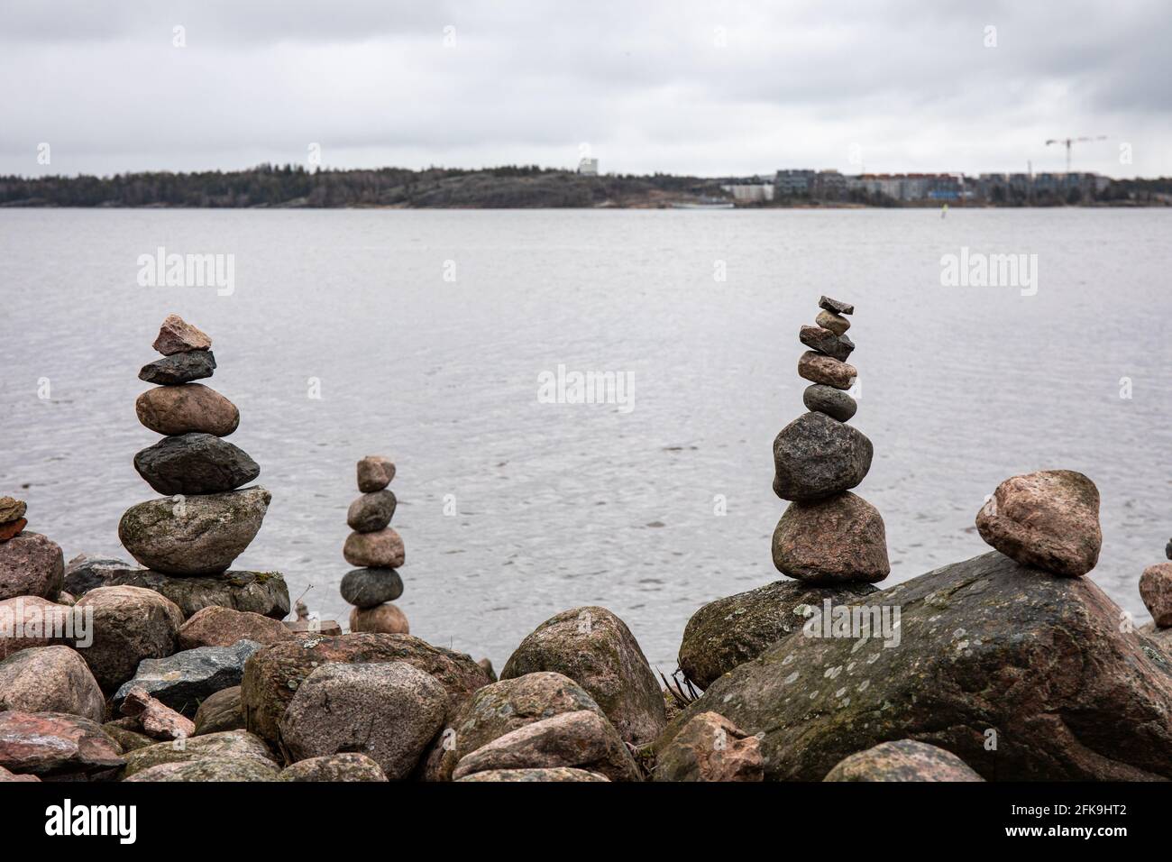 Piled up or stacked rocks on shore in Helsinki, Finland Stock Photo