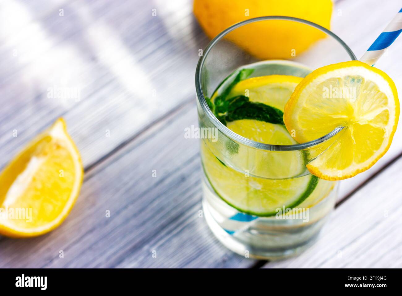 Lemon lime water with drinking straw Stock Photo Alamy