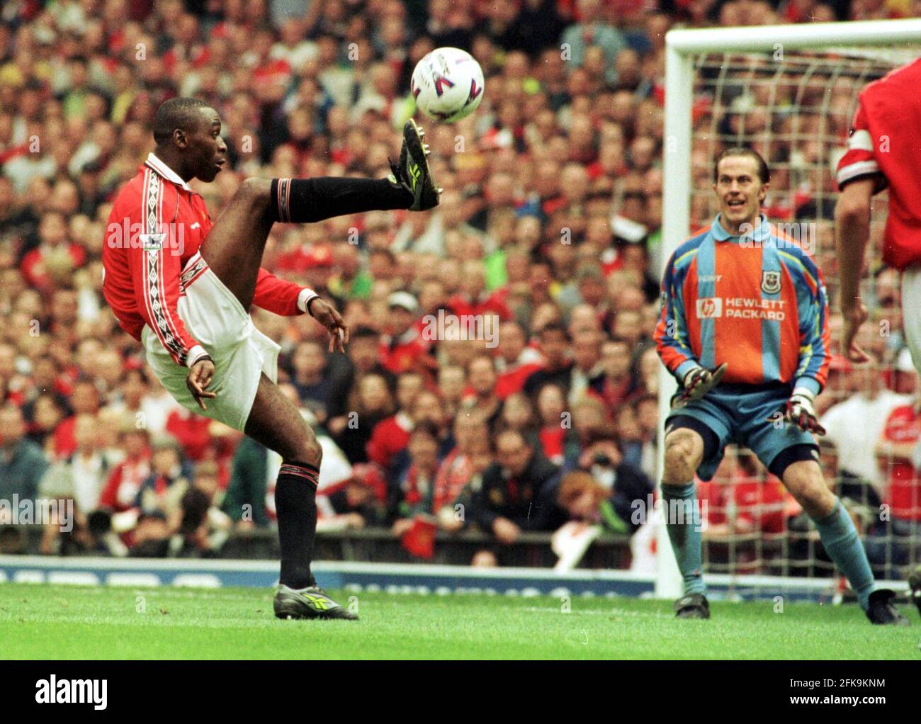 Andy Cole  scores winning goal past Ian Walker against Tottenham Hotspur on their way to winning the Premiership title at Old Trafford Stock Photo