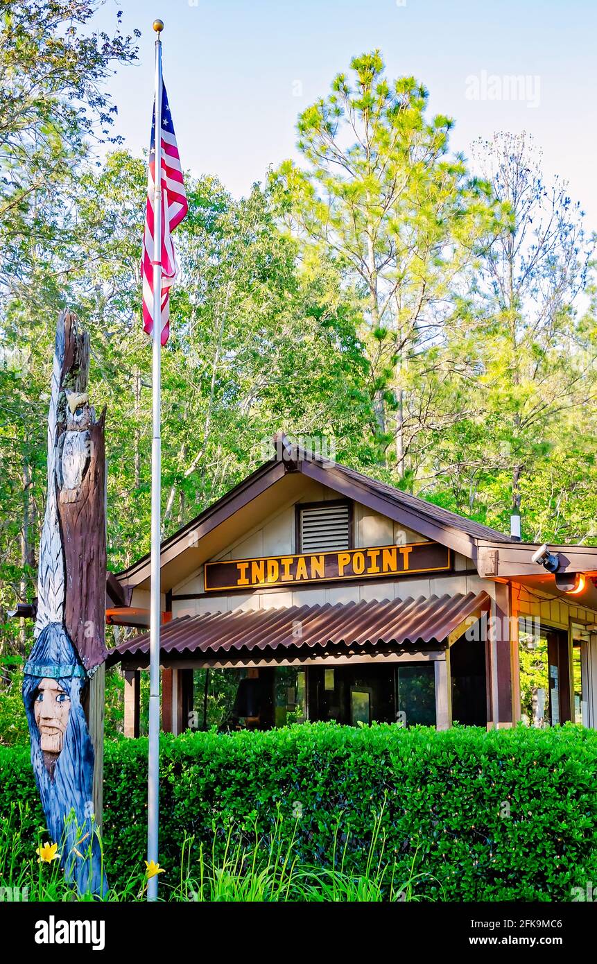 A wooden Indian princess stands with an American flag at the entrance to Indian Point RV Resort, April 25, 2021, in Gautier, Mississippi. Stock Photo