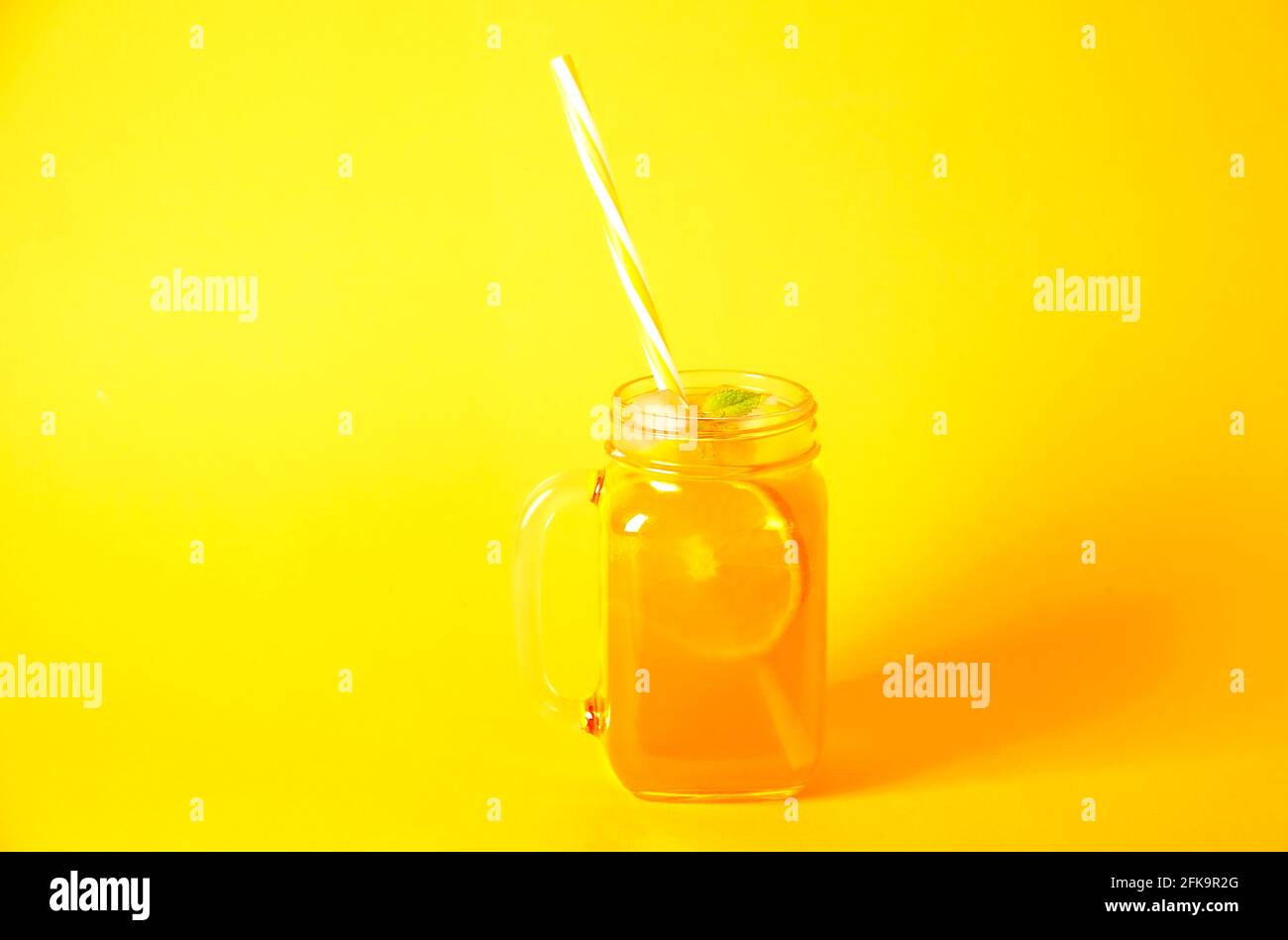 https://c8.alamy.com/comp/2FK9R2G/colorful-composition-with-vintage-mason-jar-glass-full-of-fresh-orange-juice-based-non-alcoholic-summer-cocktail-with-ice-straw-fruit-isolated-on-y-2FK9R2G.jpg