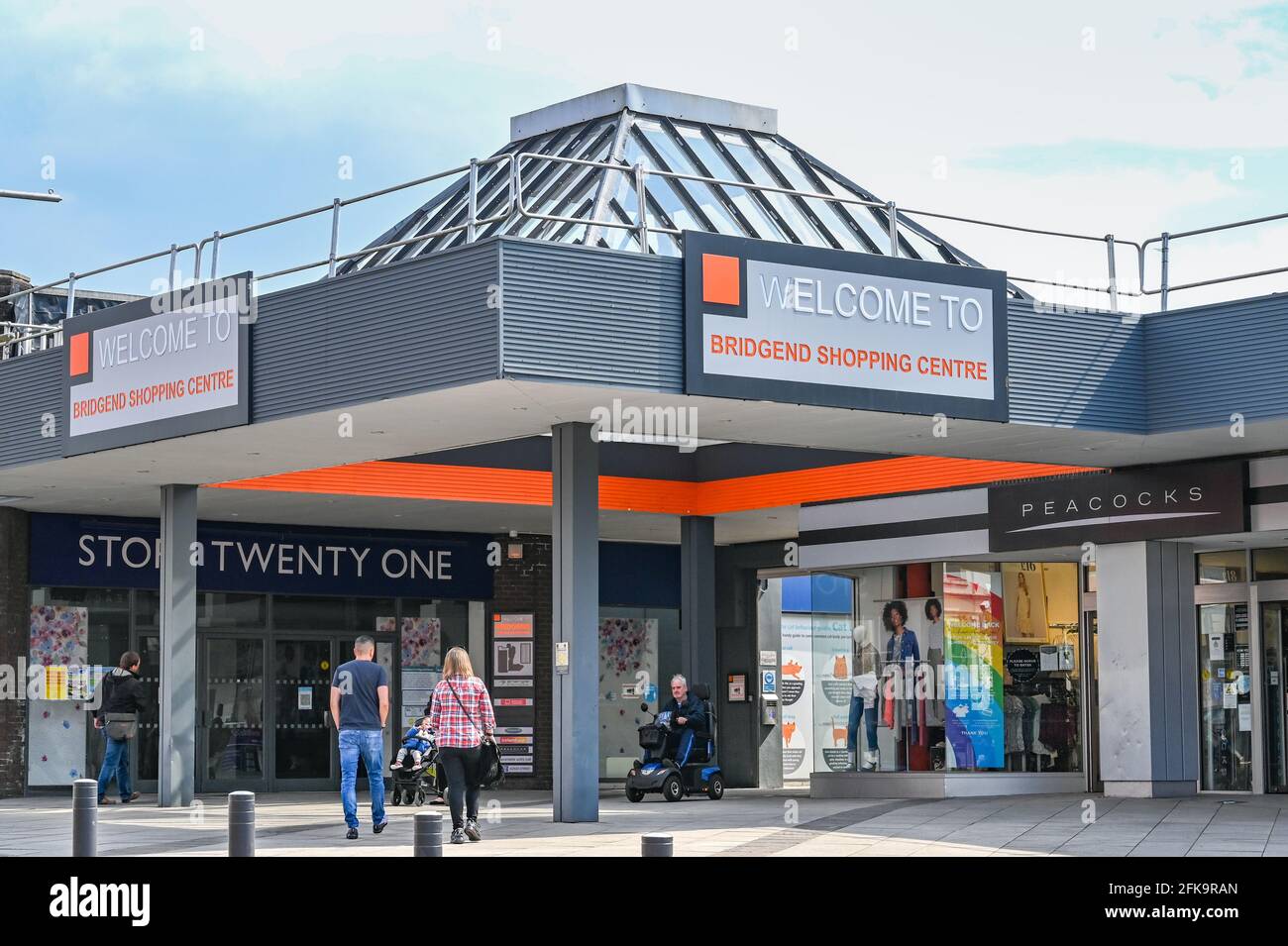 Bridgend, Wales - April 2021: People entering and leaving the Bridgend Shopping centre in the town Stock Photo