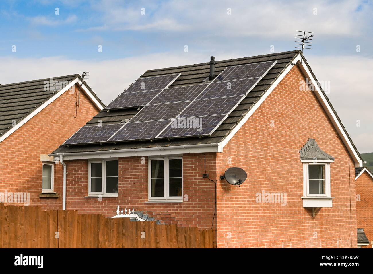 Llanharan, South Wales - April 2021: Solar panels on the roof of a detached house on a new housing development . Stock Photo