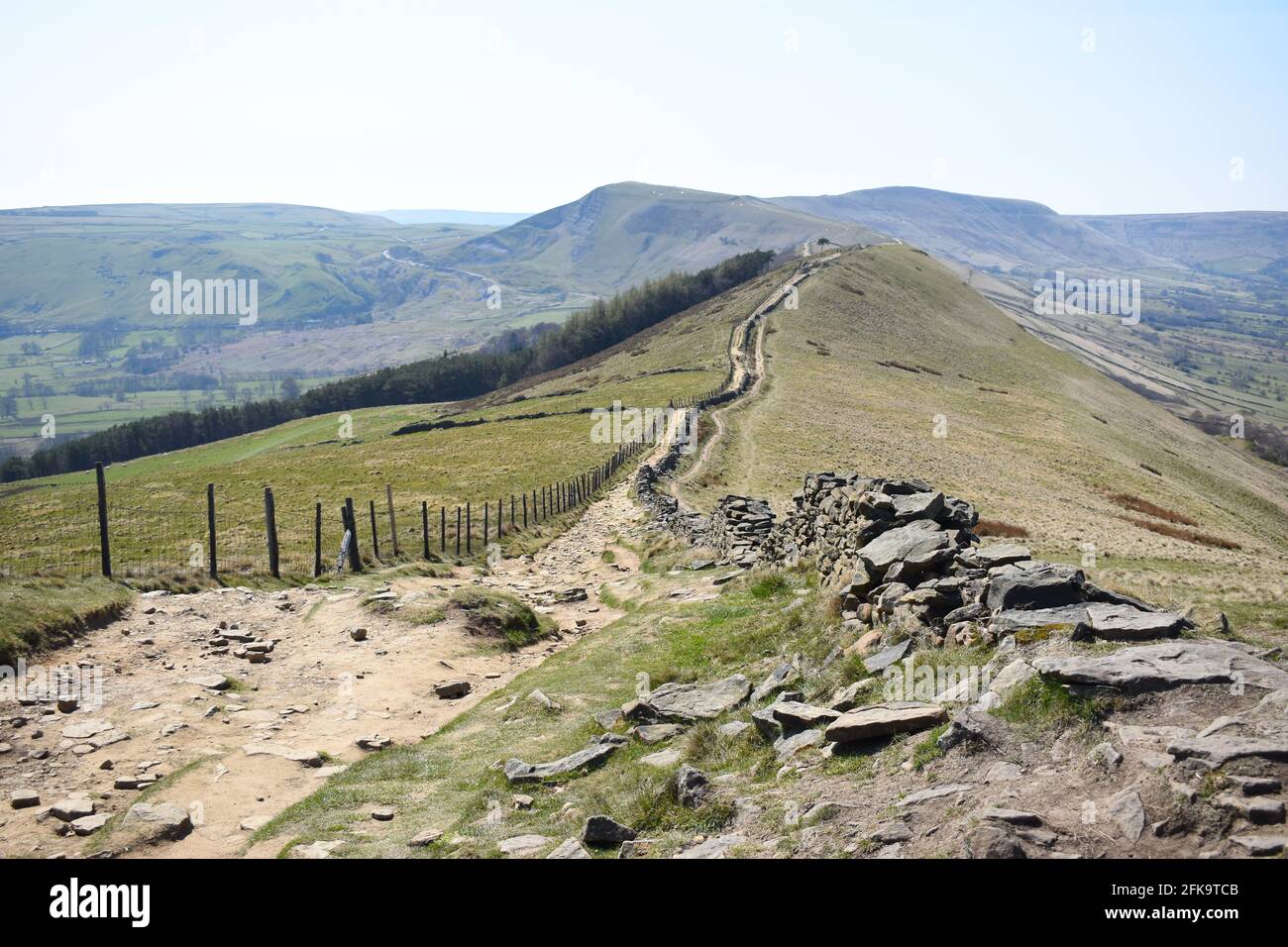 Footpath leading into the distance towards Mam Tor in the background. Mam Tor is a 517m hill near Castleton in the High Peak District, Derbyshire, UK. Stock Photo