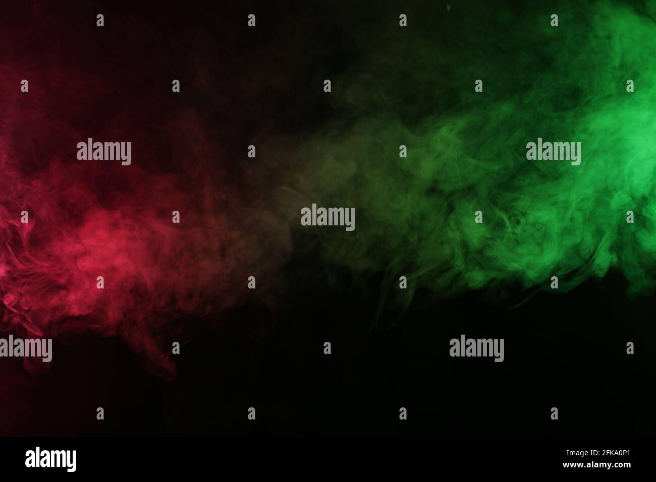 Smoke in red-green light on black background Stock Photo