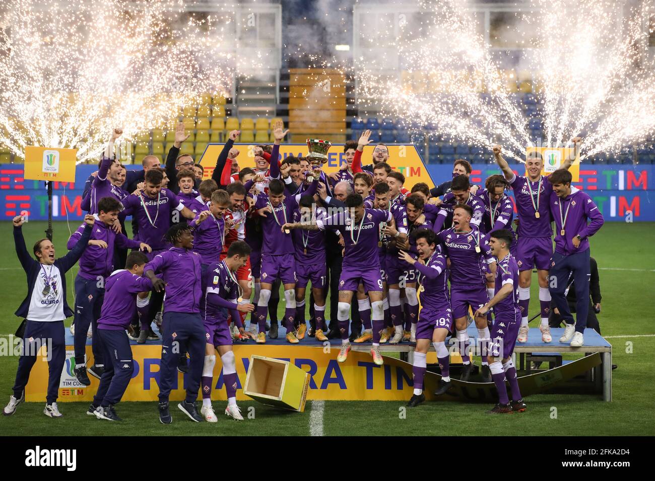 Parma, Italy, 28th April 2021. Rocco B Comisso Chairman of ACF Fiorentina  lifts the trophy along with the players as the podium begins to dismantle  during the trophy presentation of the Primavera