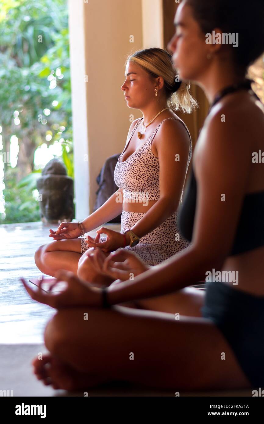 Focused young woman meditating while practicing yoga. Stock Photo