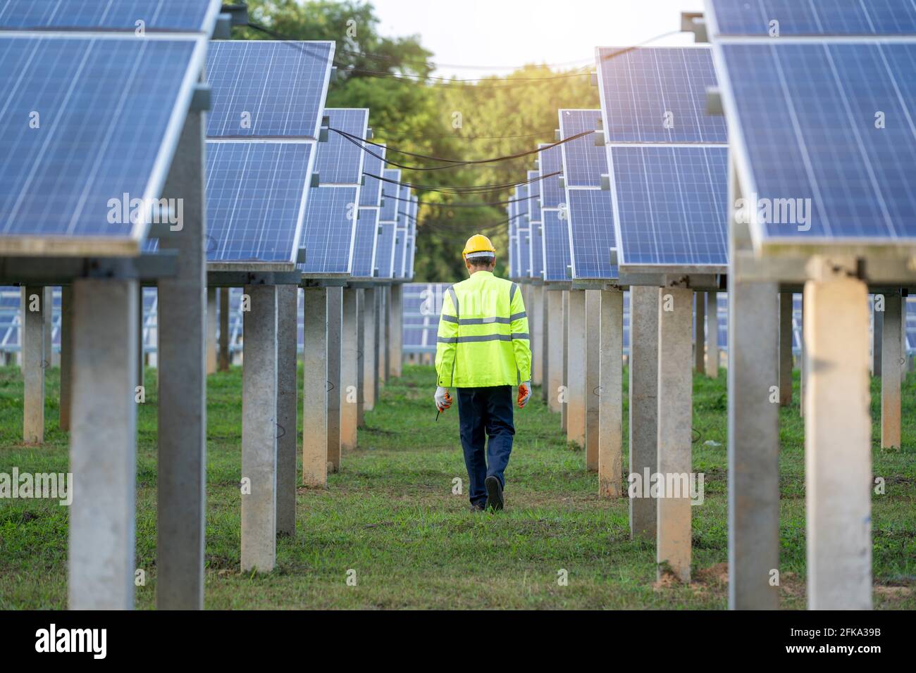 Engineer to inspect the solar panel in solar panels power farm Stock Photo