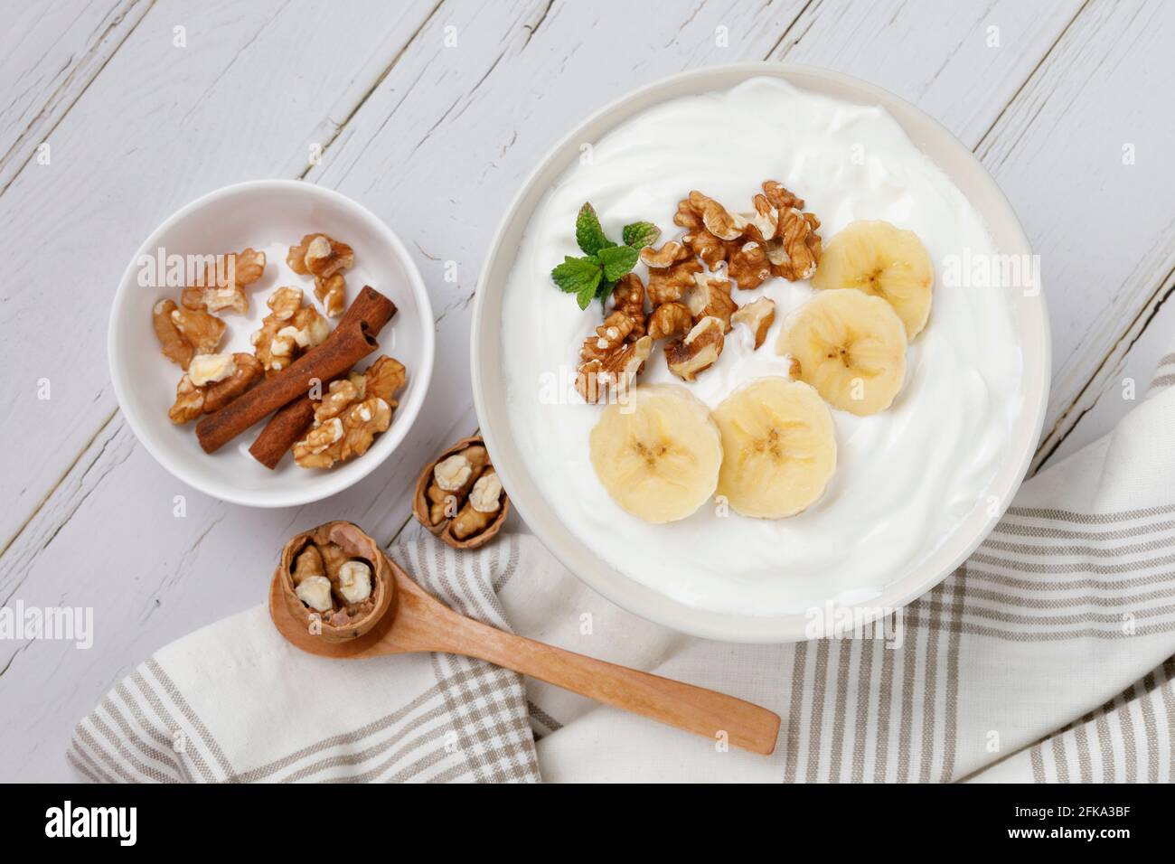 Yogurt breakfast with banana and walnuts Stock Photo Alamy