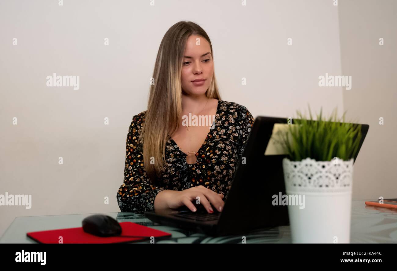 young girl working in the office with a computer Stock Photo - Alamy